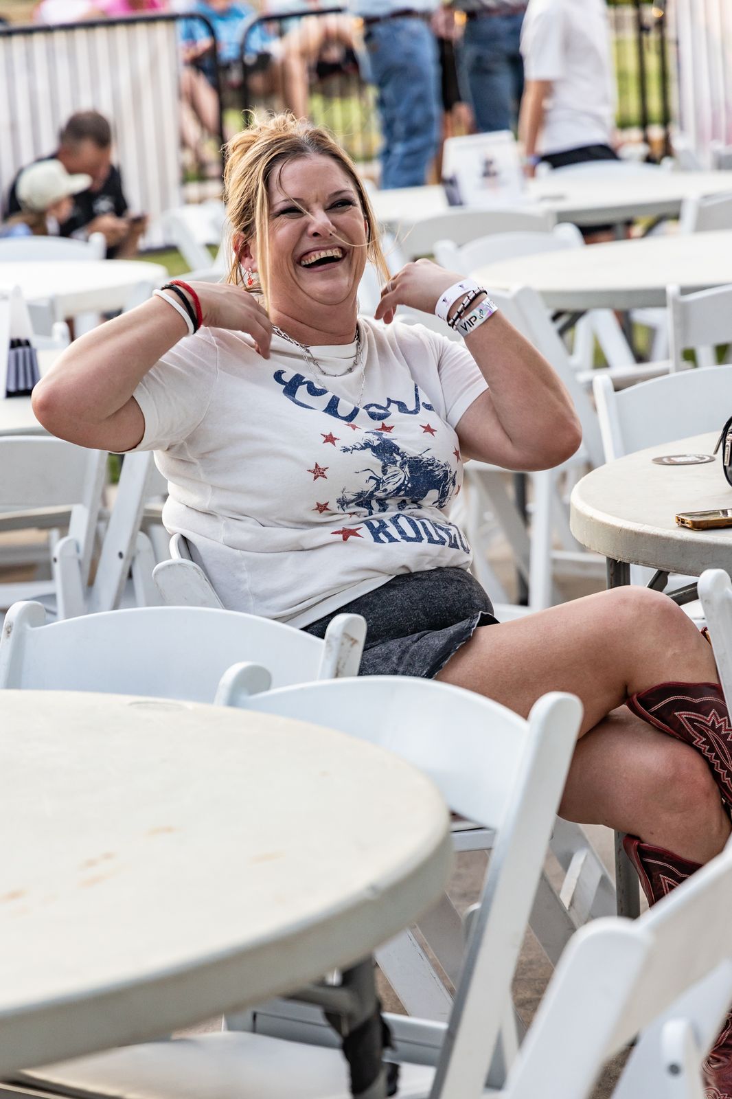 Concertgoer laughing at a table