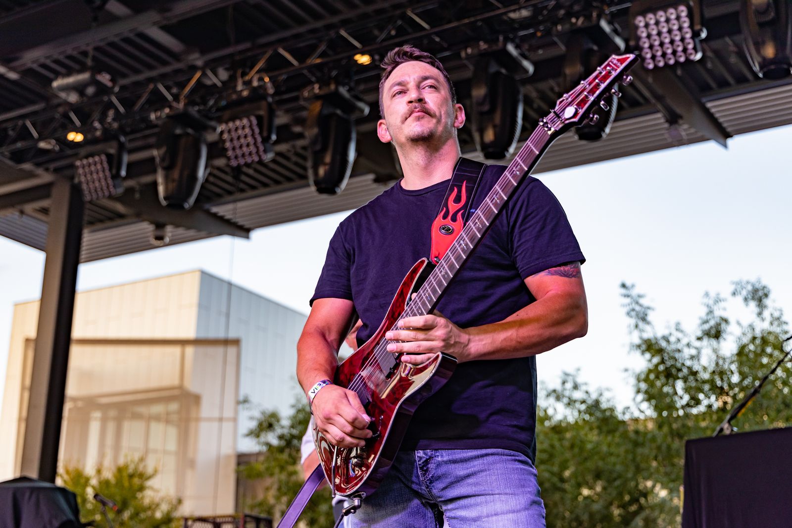 Guitarist playing an electric guitar at sunset