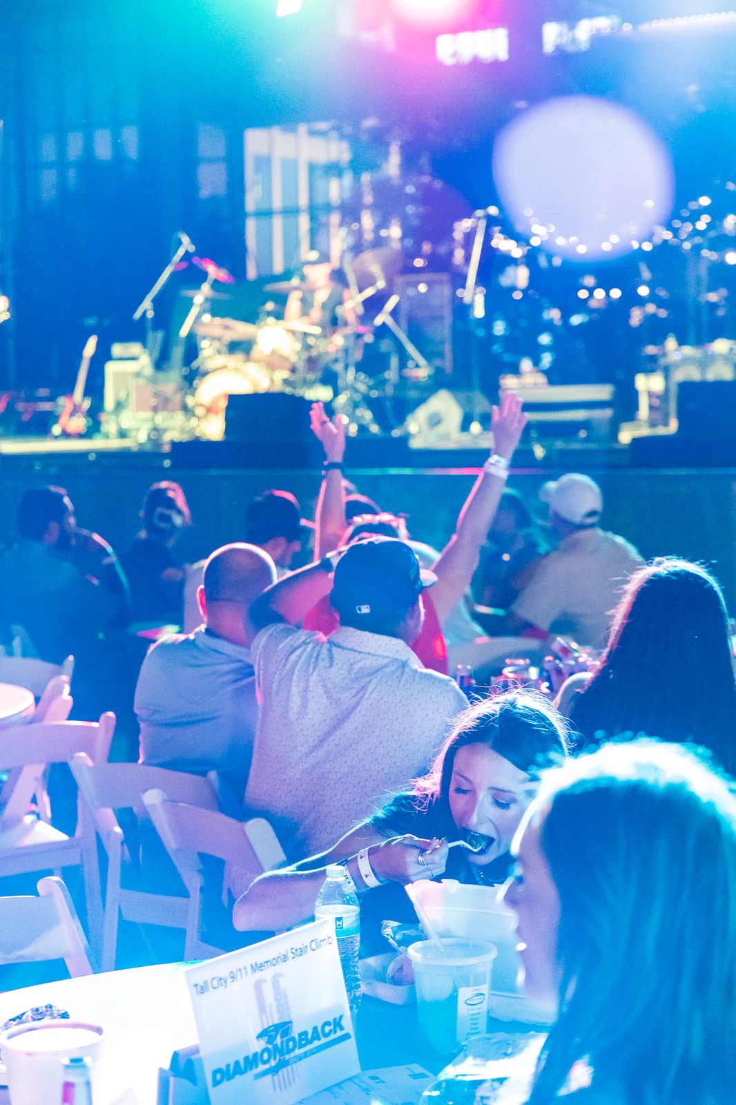 Crowd enjoying the show under colored lights